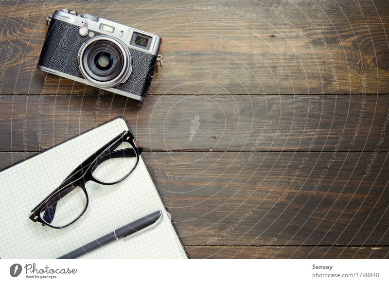 Camera, glasses and notepad on wood Style Design Desk Table Office Business Paper Pen Wood Old Above Retro Top background vintage empty space Vantage point