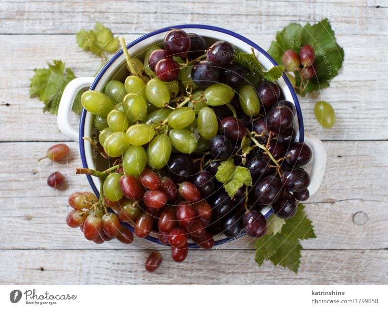 White, red and blue grapes in a bowl Fruit Nutrition Bowl Table Dark Fresh Retro Gray Green Red Agriculture Berries Food Bunch of grapes Grape vine Grapevine