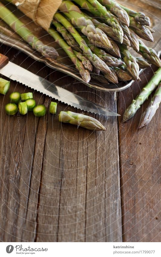 Fresh asparagus with knife Vegetable Nutrition Dinner Vegetarian diet Diet Knives Table Dark Healthy Natural Brown Green Asparagus food Gourmet wood Sliced