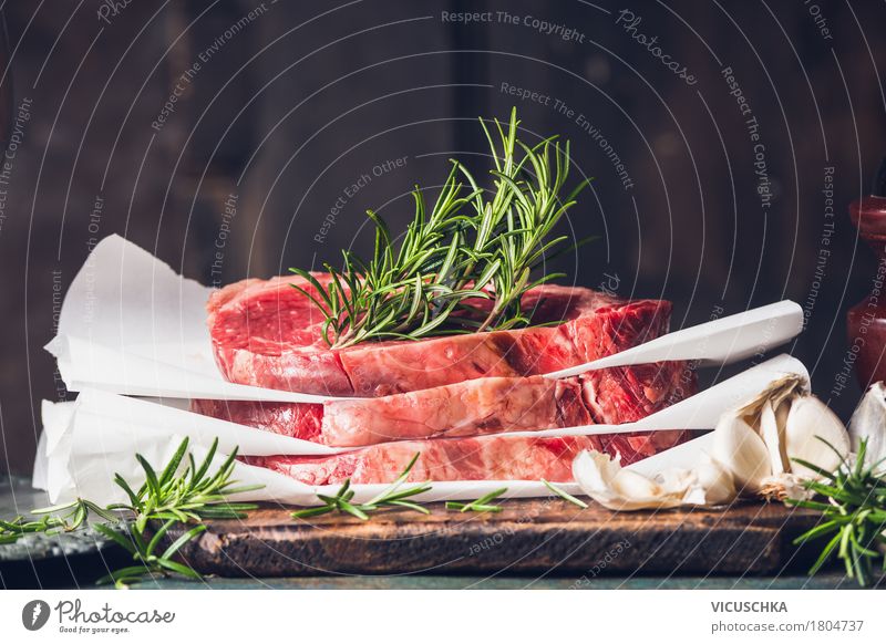 Stack of raw steaks with rosemary Food Meat Herbs and spices Nutrition Lunch Dinner Organic produce Diet Style Design Healthy Eating Table Kitchen Restaurant