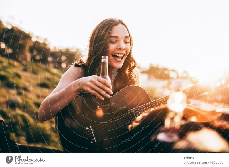 Young adult woman enjoying beer and playing guitar Beverage Drinking Alcoholic drinks Beer Bottle Lifestyle Joy Happy Freedom Summer Music Human being Girl