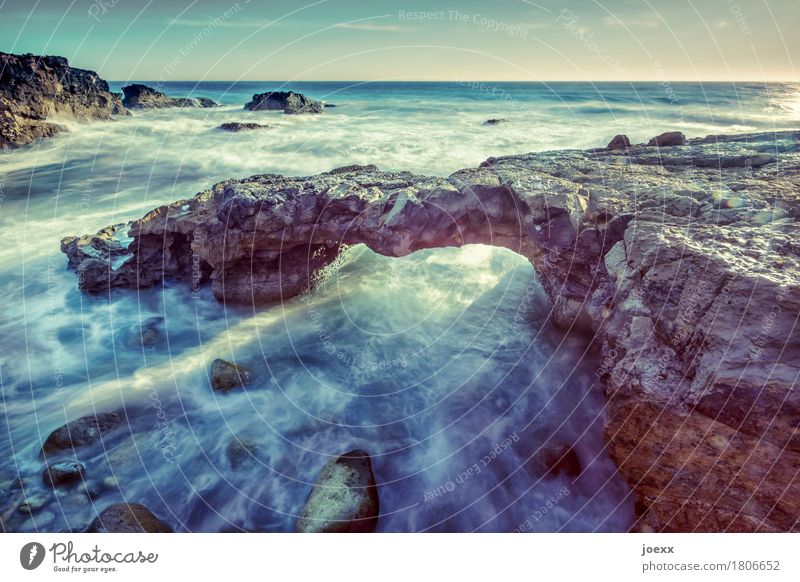 bone bridge Nature Water Sky Horizon Rock Waves Coast Ocean Wild Blue Brown White natural bridge Arch Colour photo Exterior shot Deserted Day Long exposure