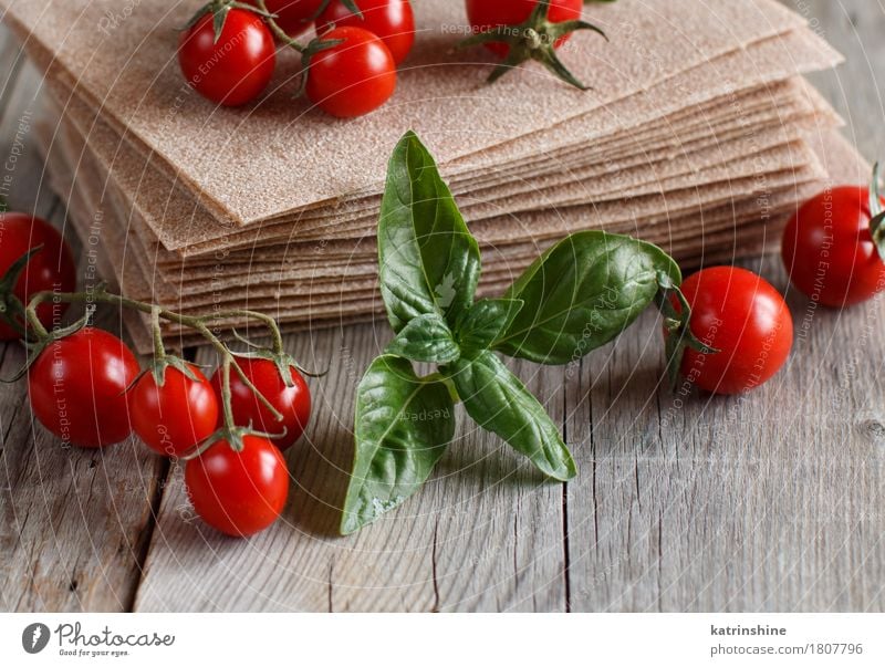 Raw lasagna sheets and cherry tomatoes Vegetable Dough Baked goods Nutrition Italian Food Table Old Brown Red Tradition Cooking Culinary food Ingredients