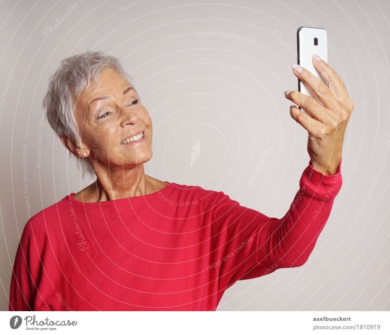 mature woman taking a selfie with smartphone Lifestyle Telephone Cellphone PDA Camera Technology Human being Woman Adults Female senior Grandmother