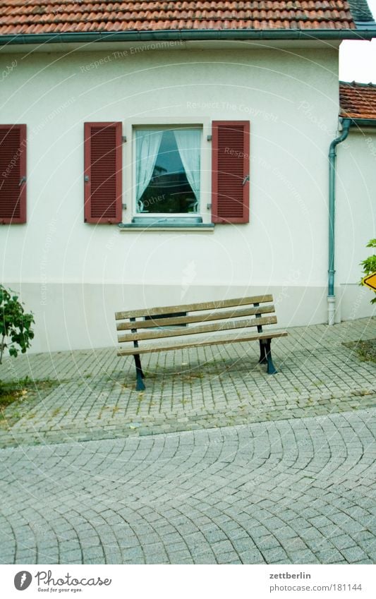 Bank in front Bench Park bench Seating Empty Expressionless Free Calm Vacation & Travel House (Residential Structure) Village Facade Window Detached house