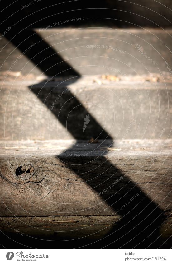 BY THE MIDDLE OF THE DAY. Colour photo Subdued colour Shadow Contrast Stairs Wood Sign Old Dark Sharp-edged Shaft of light Zigzag Upward Downward Knothole