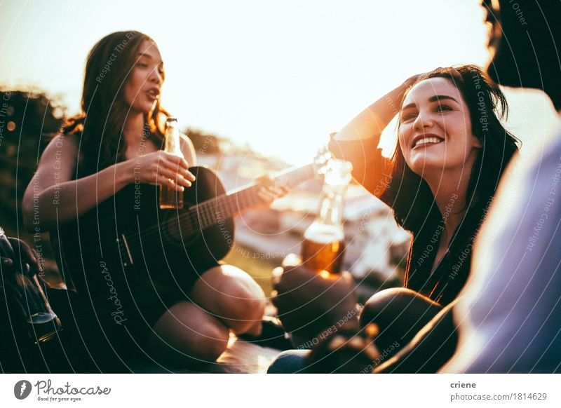 Friends having picnic and listening to music played on guitar Beverage Alcoholic drinks Beer Bottle Lifestyle Joy Summer Summer vacation Garden Party Music