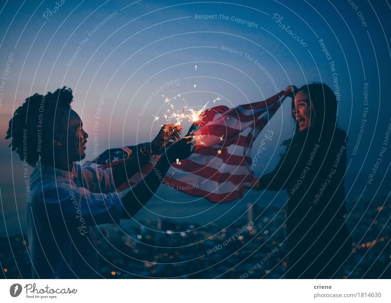 African man and Girl celebrating with USA flag and sparkler Lifestyle Joy Freedom Feasts & Celebrations Woman Adults Friendship 2 Human being Town Afro Flag