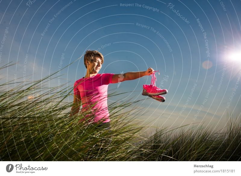 A young runner holds a pair of running shoes in her hand Walking Sports Fitness Jogging Athletic Movement Marathon workout Running Lifestyle Athlete Passion