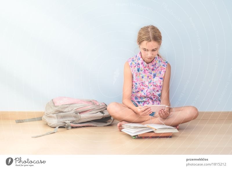 Schoolgirl reading a book in classroom Lifestyle Reading Education Classroom Schoolchild Student Academic studies Cellphone Tool Girl 1 Human being