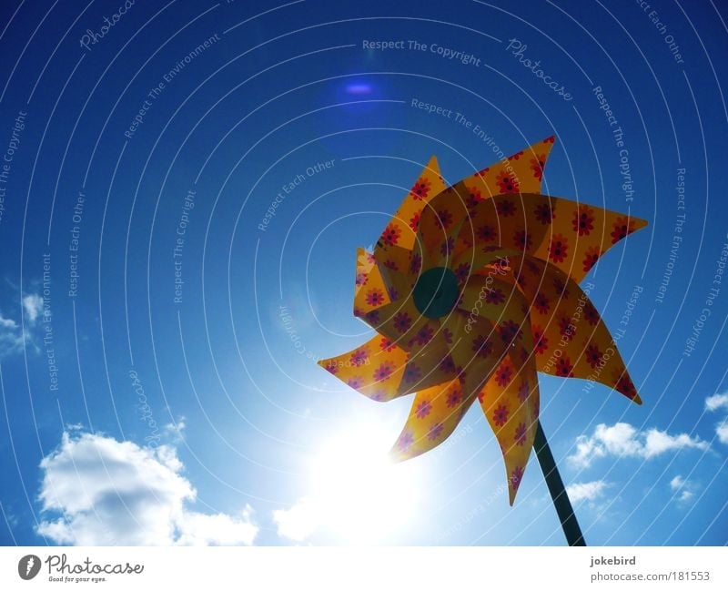 Sun on a stick Sky Clouds Beautiful weather Wind Toys Rotate Bright Blue Yellow Pinwheel Summer Climate Isolated Image Bright background Lens flare Blue sky