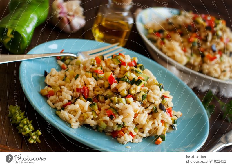 Risotto with vegetables Vegetable Grain Herbs and spices Cooking oil Nutrition Lunch Dinner Vegetarian diet Diet Italian Food Plate Bottle Fork Wood Delicious