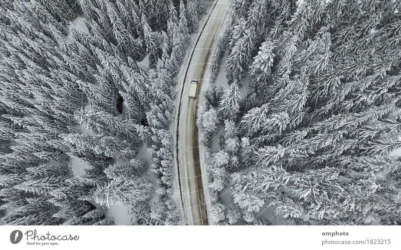 Air view of a snowy and frozen winter road with a moving car on it Winter Snow Mountain Nature Landscape Tree Forest Street Car View from the airplane Freeze