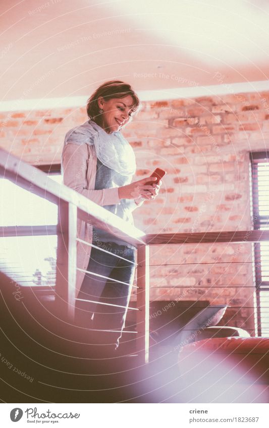 Caucasian woman smiling at her smartphone Joy Reading Living room Work and employment Office Business Cellphone PDA Technology Telecommunications