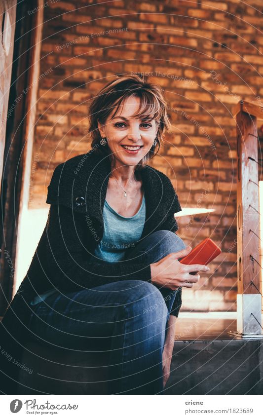 Mature Happy Woman smiling in Camera holding smartphone in hands Lifestyle Joy Room Living room Workplace Office Business Telephone Cellphone PDA Technology