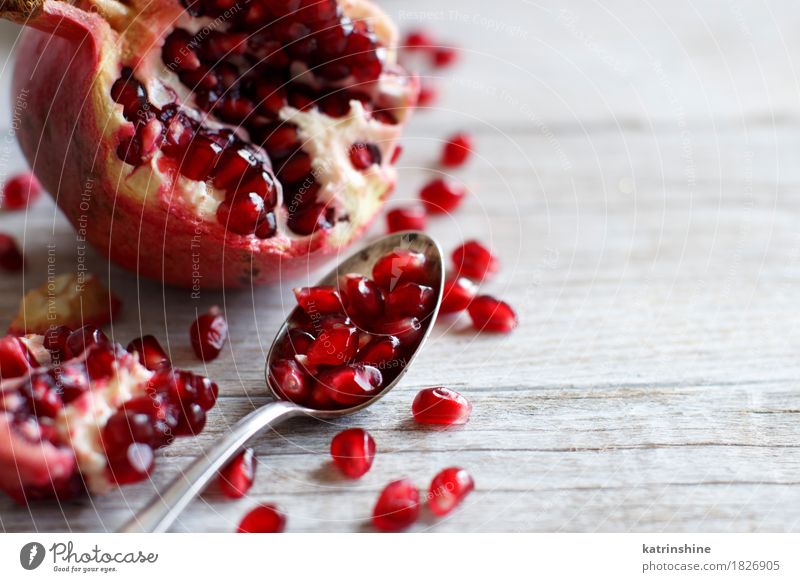 Open fresh ripe pomegranates Fruit Nutrition Vegetarian diet Diet Spoon Exotic Wood Fresh Delicious Juicy Brown Red agriculture antioxidant food Garnet healthy