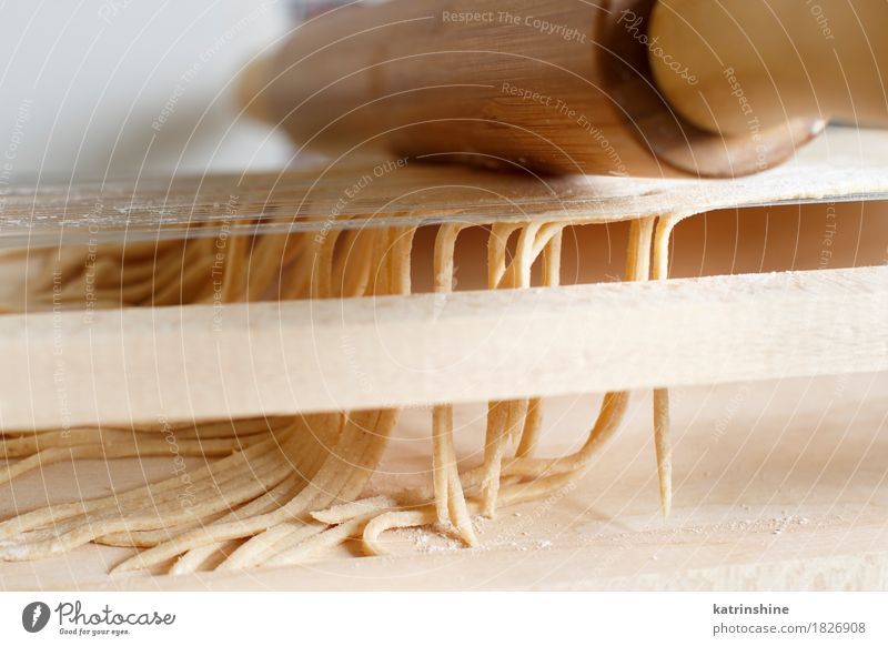 Making spaghetti alla chitarra with a tool Dough Baked goods Nutrition Italian Food Table Kitchen Tool Guitar Make Dark Fresh Tradition Ingredients manual