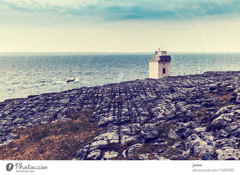 small light Water Sky Rock Waves Coast Ocean Island Ireland Lighthouse Building Fishing boat Driving Small Blue Brown Gray White Bizarre Horizon Colour photo