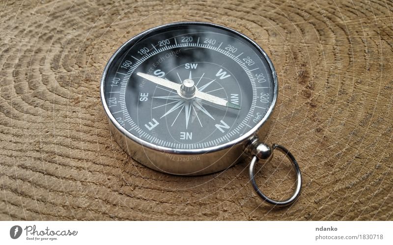 Metal compass on a tree stump Style Vacation & Travel Trip Tool Old Small Retro Brown Antique direction equipment exploration Geography instrument navigation