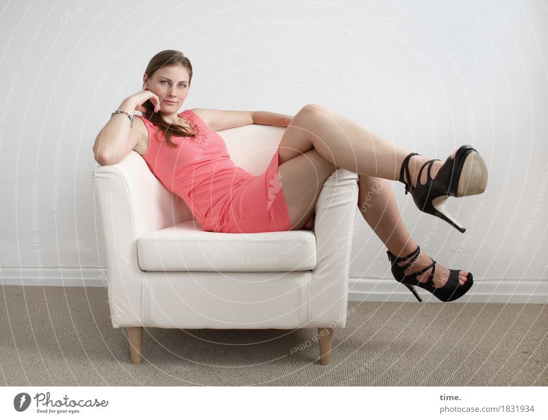 . Armchair Room Feminine Dress High heels Brunette Long-haired Braids Observe Think Relaxation Looking Sit Wait Beautiful Contentment Safety (feeling of)