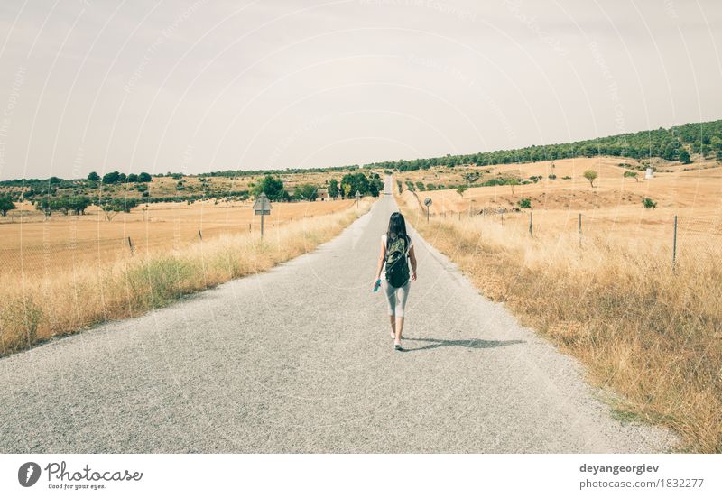 Woman with backpack walking on the road Lifestyle Beautiful Vacation & Travel Trip Summer Human being Girl Adults Cinema Nature Sky Tree Grass Street