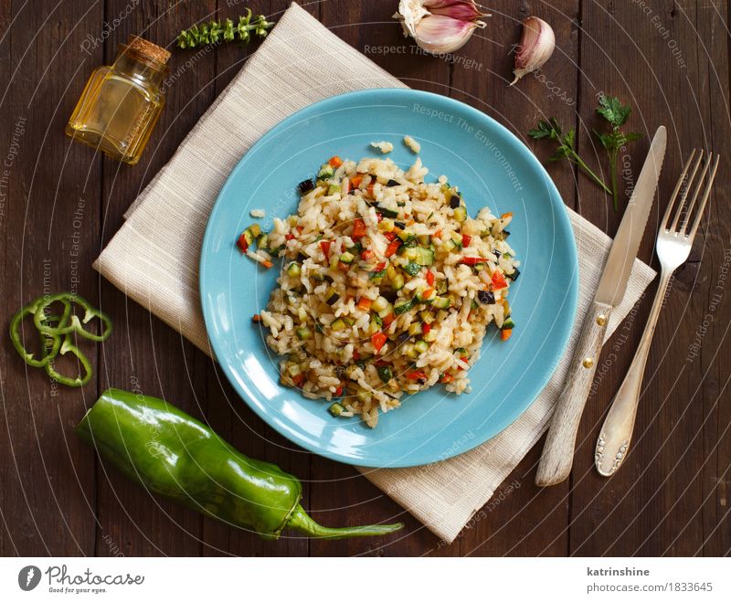 Risotto with vegetables Food Vegetable Grain Herbs and spices Cooking oil Nutrition Lunch Dinner Vegetarian diet Diet Plate Bottle Knives Fork Wood Healthy