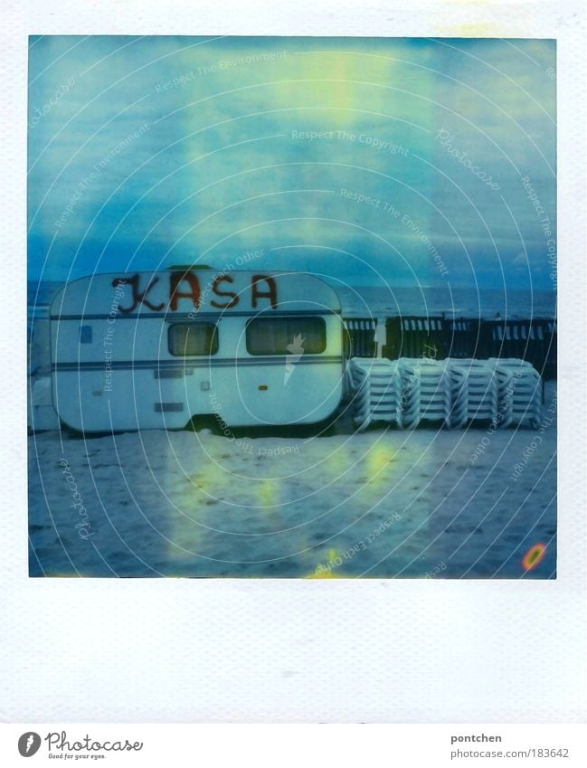Caravan with the inscription kasa Kasse is located on the beach. Rental. Beach chairs. Beach chairs Colour photo Subdued colour Exterior shot Polaroid