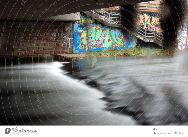 floating underground Colour photo Exterior shot Day Motion blur Water River bank Brook Bridge Manmade structures Lanes & trails Sign Characters Graffiti Gray