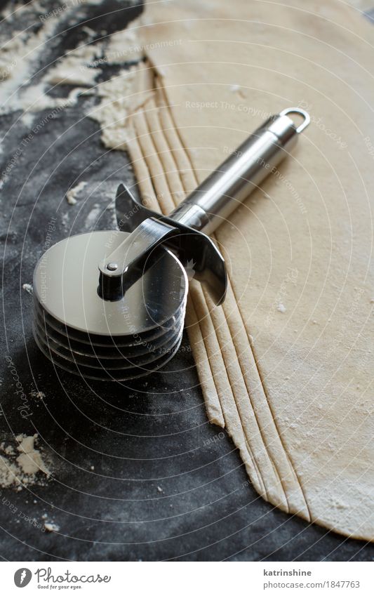 Making homemade taglatelle with a pasta rolling cutter Dough Baked goods Nutrition Table Kitchen Tool Make Dark Fresh Tradition Ingredients Italian manual