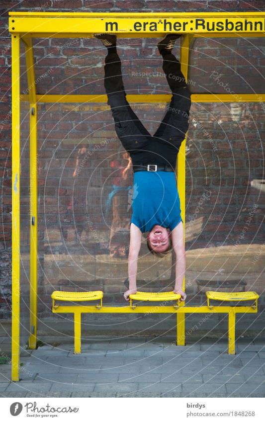 Young man doing a handstand in a bus shelter Athletic Fitness Sports Training Masculine Youth (Young adults) 1 Human being 18 - 30 years Adults Shelter Bus stop