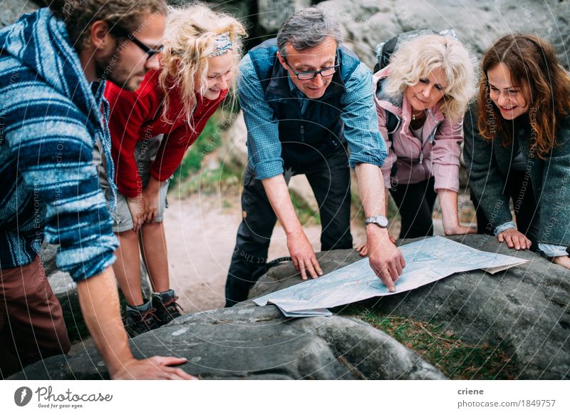 Group of Hikers checking route on map in the mountains Lifestyle Joy Relaxation Leisure and hobbies Vacation & Travel Tourism Trip Adventure Expedition Camping