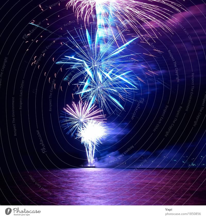 Blue and red colorful holiday fireworks Joy Night life Entertainment Party Event Feasts & Celebrations Christmas & Advent New Year's Eve Water Sky Night sky