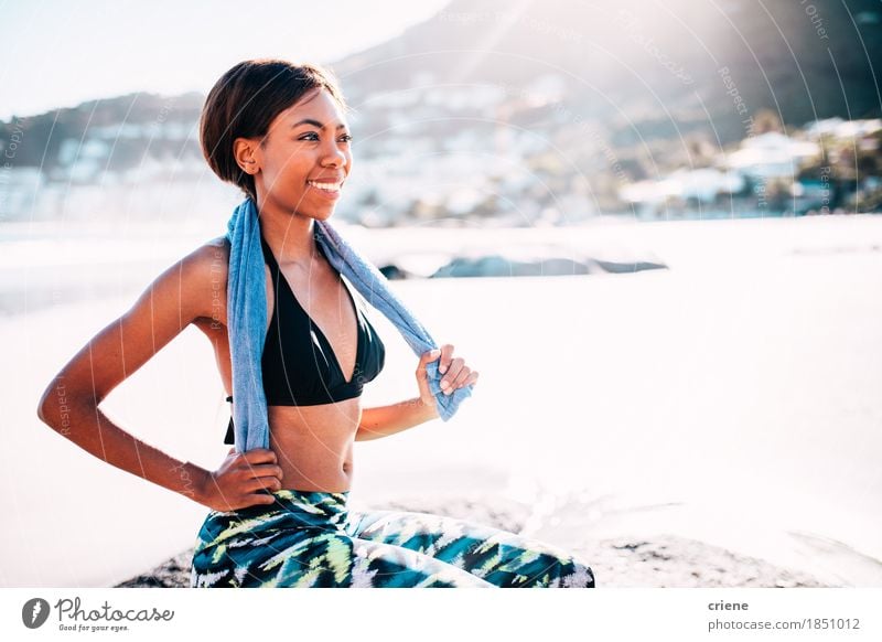 African young women sitting on beach after fitness workout - a Royalty Free  Stock Photo from Photocase
