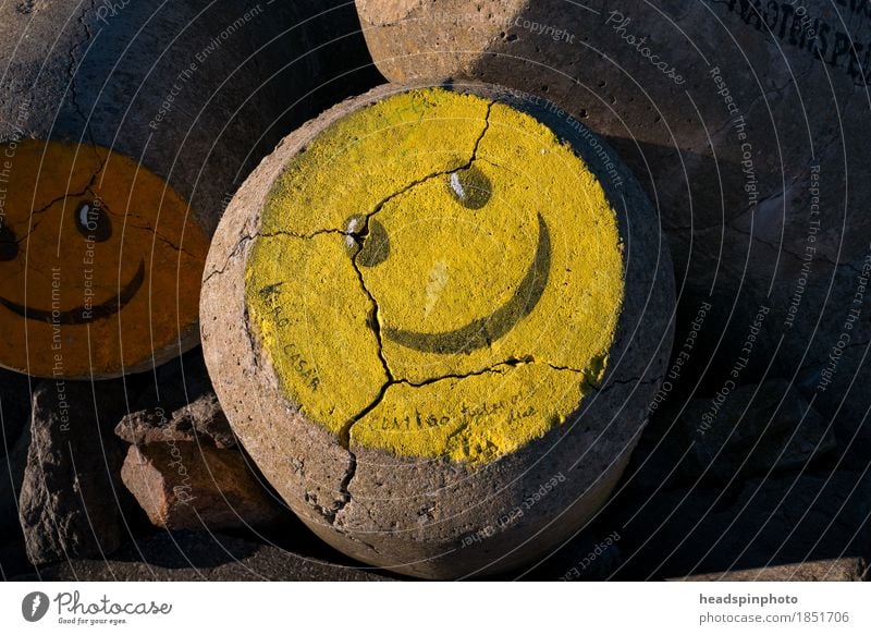 Yellow smiley on a water breaker in Aveiro, Portugal Vacation & Travel Tourism Beach Ocean Waves Work of art Painting and drawing (object) Stone Sign Graffiti