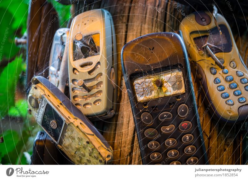 Old broken mobile phones nailed to a trunk To talk Telephone Cellphone Screen Technology Telecommunications Information Technology Paper