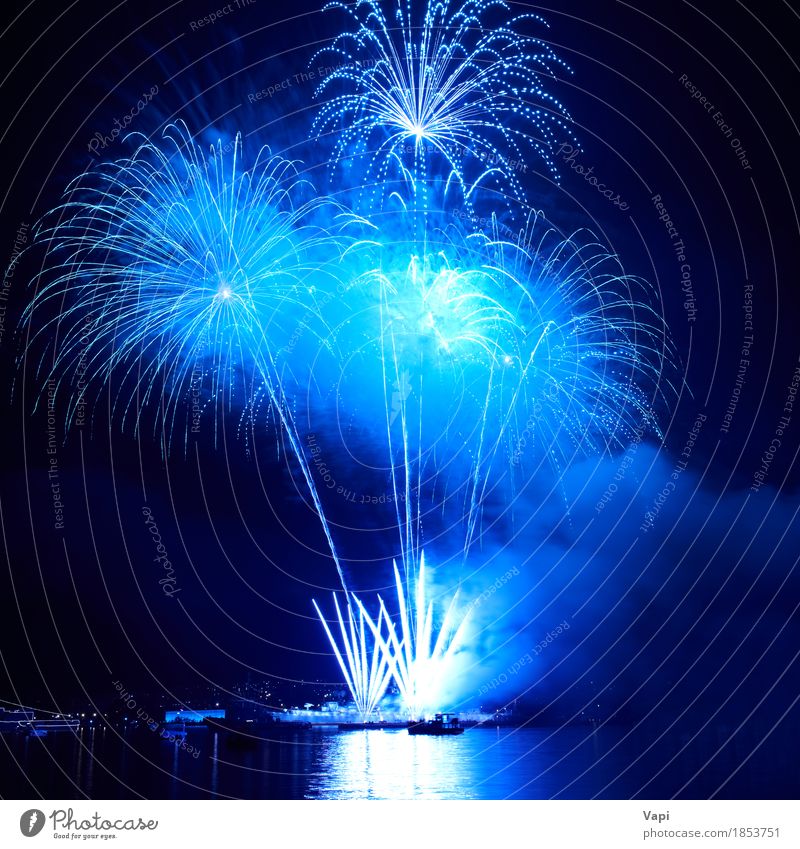 Blue colorful fireworks on the black sky Joy Freedom Night life Entertainment Party Event Feasts & Celebrations Christmas & Advent New Year's Eve Art Shows