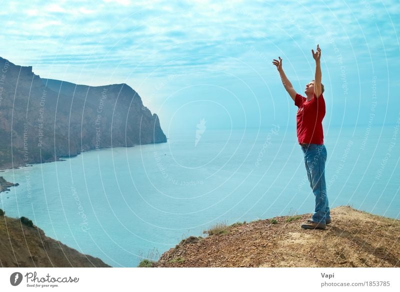Happy man standing on the cliff with hands up Lifestyle Joy Vacation & Travel Adventure Freedom Sun Ocean Mountain Success Human being Young man