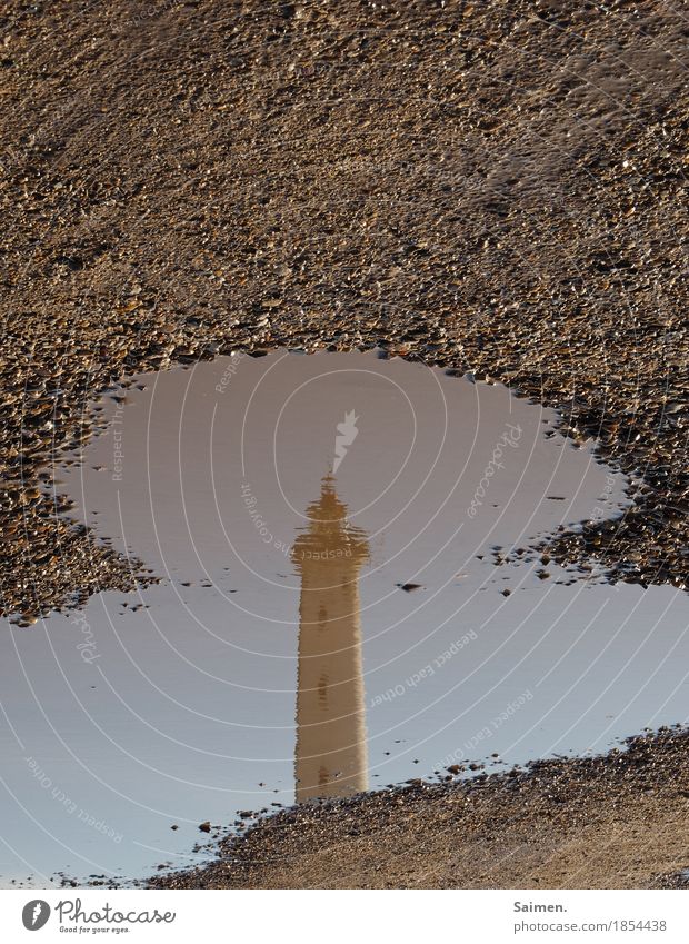 mirror perspective Lighthouse Tourist Attraction Vacation & Travel Puddle Sand Reflection Water Round Stone Tower Spire Vantage point Colour photo