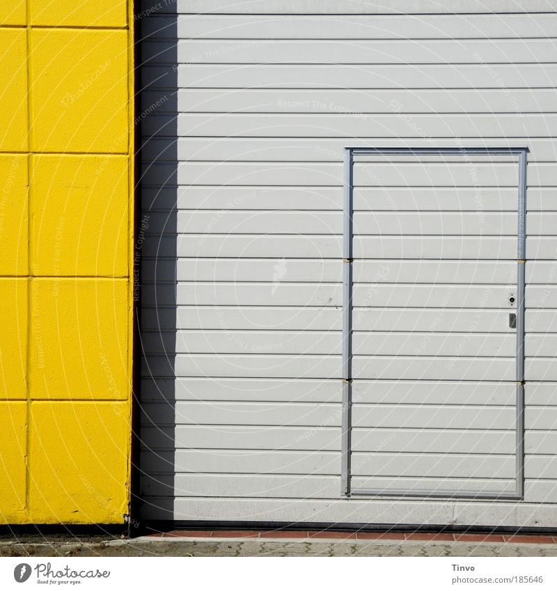 note entrance Industrial plant Building Wall (barrier) Wall (building) Facade Door Yellow Gray Striped Checkered Entrance Front door Way out Rolling door