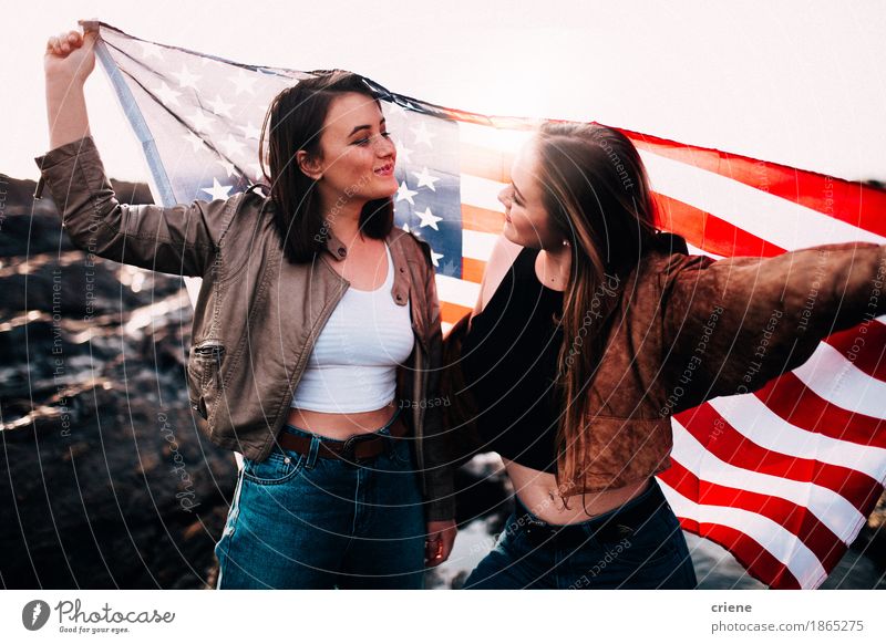 Teenage girls holding USA flag outdoor Lifestyle Joy Vacation & Travel Tourism Trip Adventure Freedom Summer vacation Beach Feasts & Celebrations Young woman