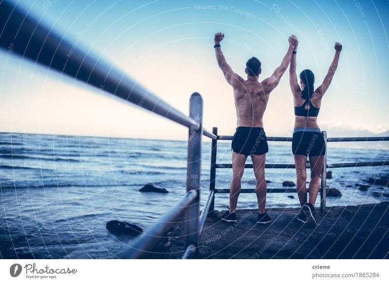 Young adult caucasian couple doing conquer pose after run Lifestyle Joy Happy Body Healthy Athletic Fitness Well-being Leisure and hobbies Freedom Beach