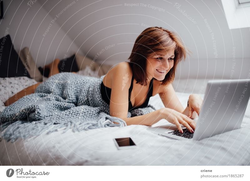 Young caucasian women laying in bed with laptop Lifestyle Joy Living or residing Flat (apartment) Bedroom Education Study University & College student