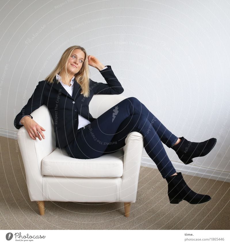 Woman in an armchair Armchair Room Feminine 1 Human being Shirt Pants Jacket Boots Blonde Long-haired Smiling Looking Sit Funny pretty Joy Happy Happiness