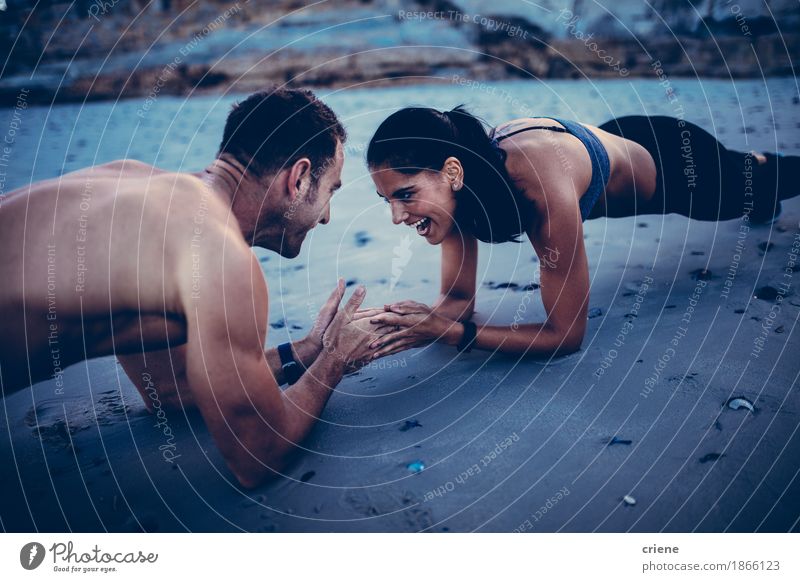 Young fit caucasian couple having fun doing fitness exercise Lifestyle Joy Leisure and hobbies Beach Sports Fitness Sports Training Sportsperson Friendship