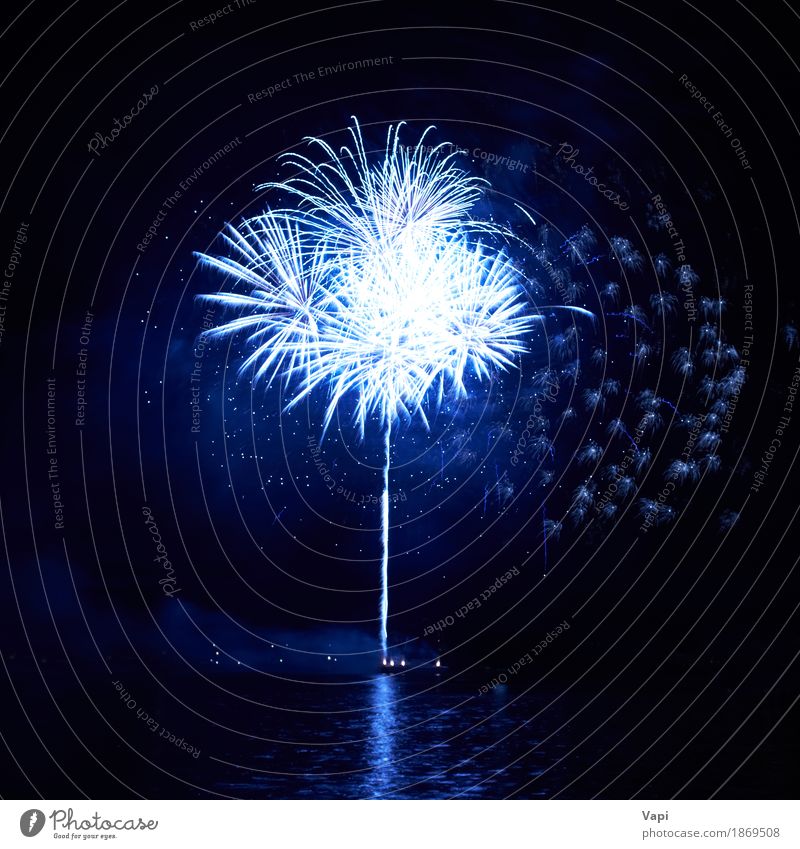 Blue fireworks with water reflection Joy Freedom Night life Entertainment Party Event Feasts & Celebrations Christmas & Advent New Year's Eve Art Shows Water