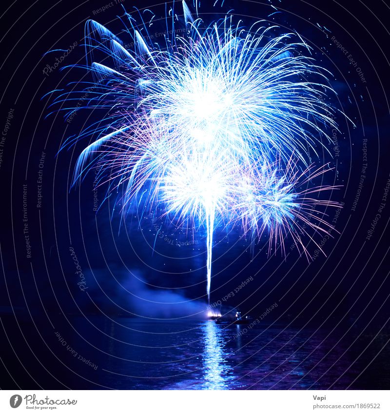 Blue fireworks with water reflection Joy Freedom Night life Entertainment Party Event Feasts & Celebrations Christmas & Advent New Year's Eve Art Water Sky