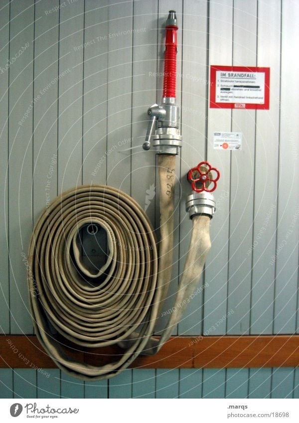 In case of fire Extinguisher Hose Lever Hang Red Wall (building) Burn Emergency Accident Industry Fear Panic Help Blaze coiled Fire department Tap