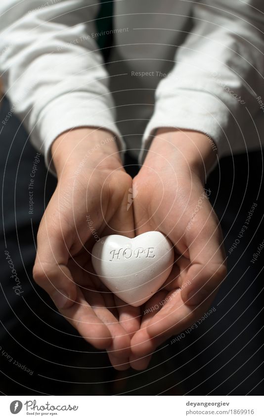 Child hold in hands heart. Text hope. Life Arm Hand Heart Emotions Passion Hope Expectation Peace care Symbols and metaphors people Charity help health Hold