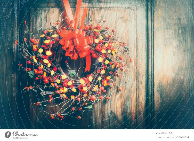 Christmas wreath on wooden door with red ribbon, berries and bokeh Style Design Winter Living or residing Interior design Decoration Feasts & Celebrations