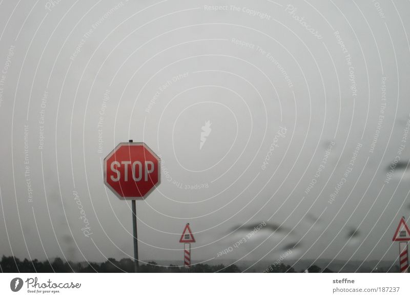 IN THE NAME OF LOVE Bad weather Rain Road sign Stop sign St. Andrew's Cross Railroad crossing Stagnating Colour photo Exterior shot Deserted Copy Space top